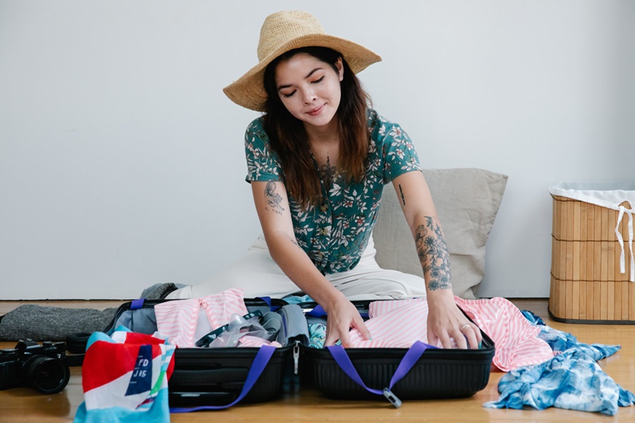Printable Vacation Rental Packing List a Woman Packing a Suitcase
