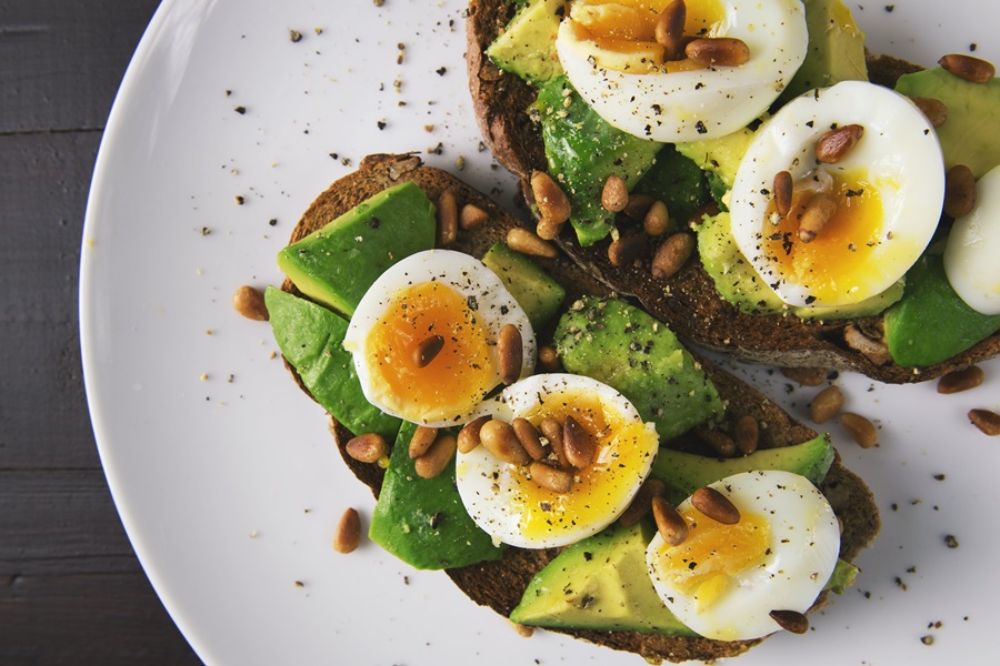 Core De Force Meal Plan Tips Close Up of Avocado Toast Topped with Hard Boiled Egg Slices and Pepper