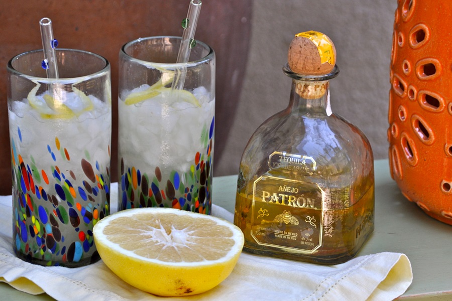 Patron Grapefruit Margarita Patron Grapefruit Cocktail Recipe Close Up of Two Glasses Filled with Grapefruit Margaritas Next to a Bottle of Patron and a Half a Grapefruit