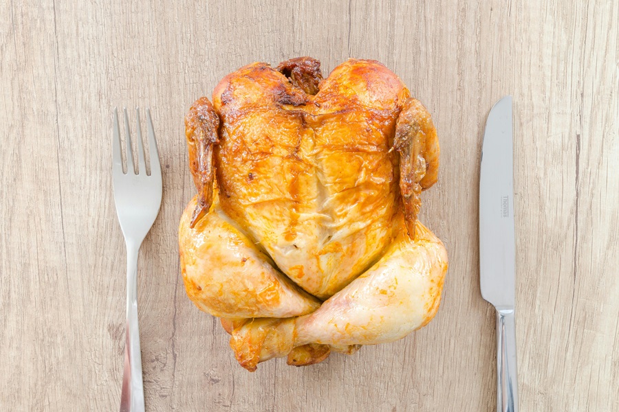 Intermittent Fasting Lunch Recipes with Chicken Close Up of a Full Roasted Chicken with a Fork on One Side and a Knife on the Other