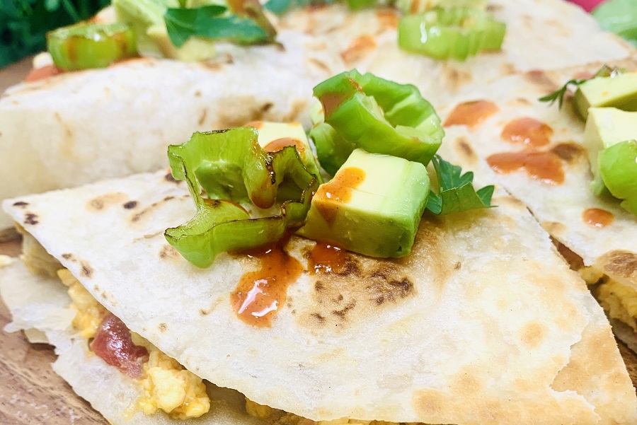 Healthy Breakfast Quesadilla Recipe Finished Quesadilla on a Cutting Board Close Up with Avocado