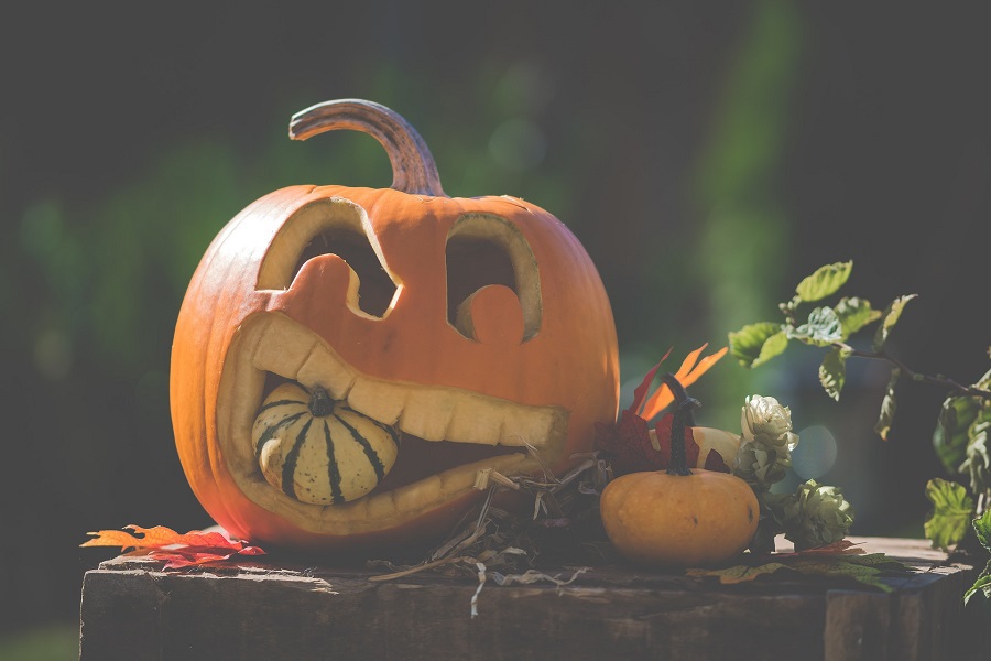 Halloween Crockpot Recipes Carved Pumpkin Holding Another Pumpkin in its Mouth