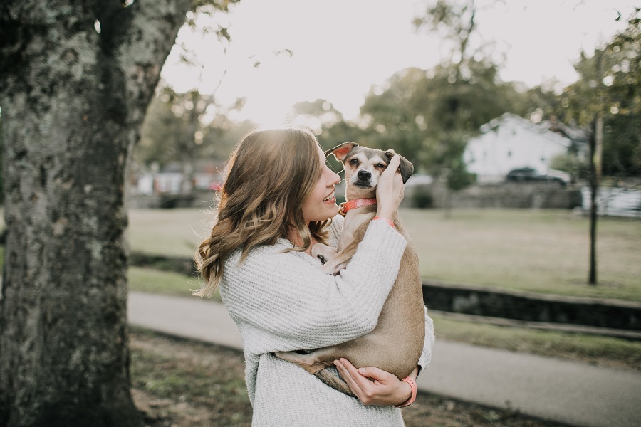 Colloidal Silver Uses a Woman Holding Her Dog and Smiling Next to a Tree