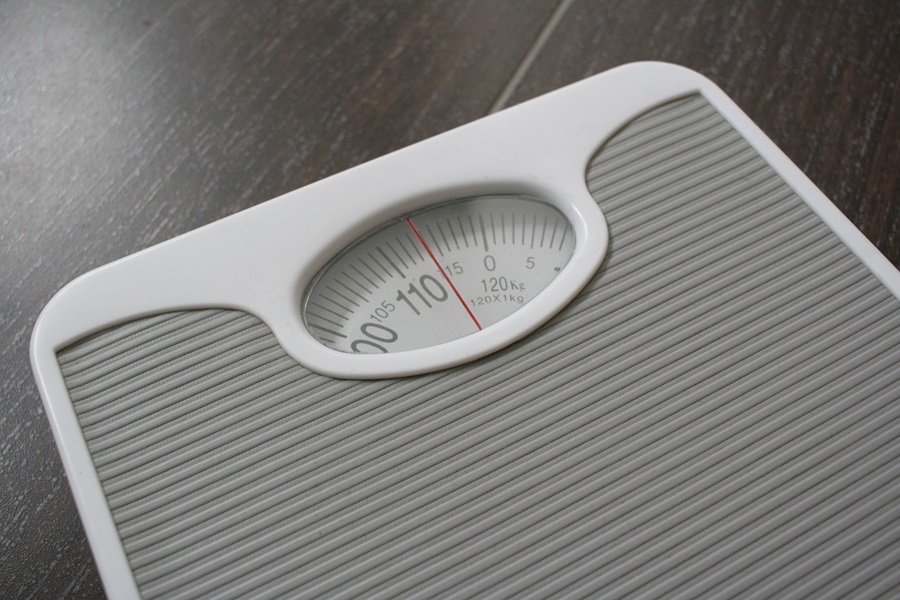 How to Get your Body in Ketosis Close Up of a Scale on a Wood Floor