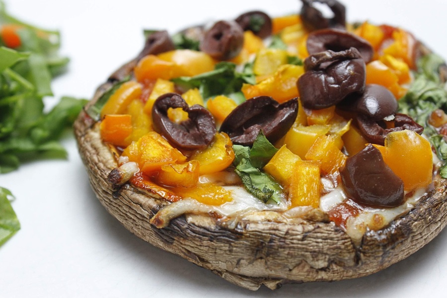Easy Healthy Mushroom Pizza Recipe Close Up of a Portobello Mushroom Pizza with Diced Peppers, Olives and Basil