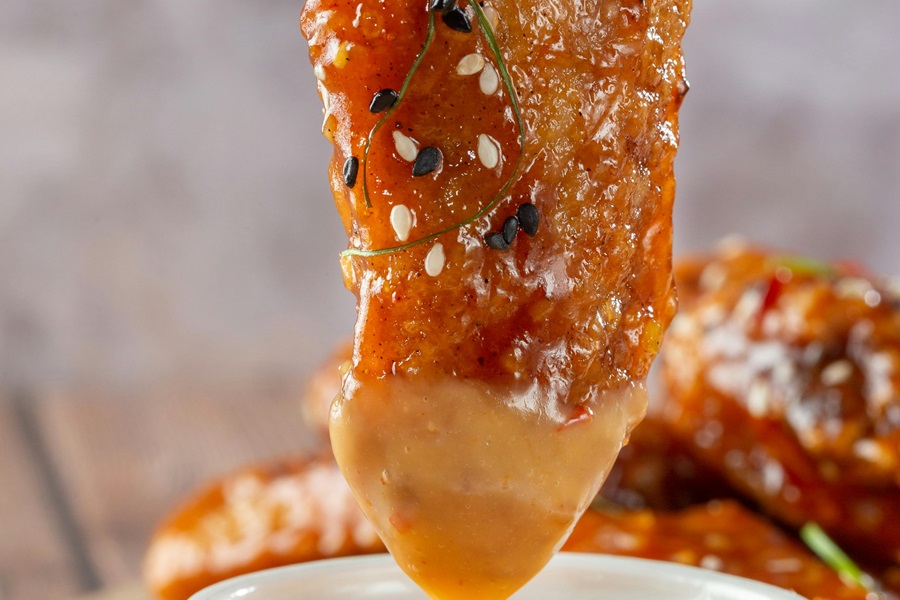 21 Tasty Ketogenic Chicken Strips Recipes Close Up of a Chicken Strip in a Honey Sauce