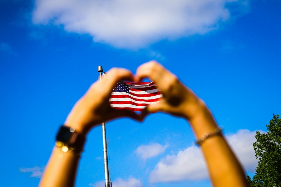 55 Patriotic Dessert Recipes View of an American Flag Through a Person's Hands Held Together in the Shape of a Heart