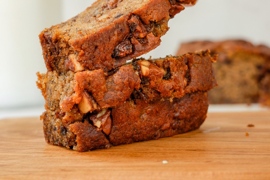 Best Gluten Free Dairy Free Banana Bread Recipes Close Up of a Pile of Banana Bread Slices on a Wooden Cutting Board