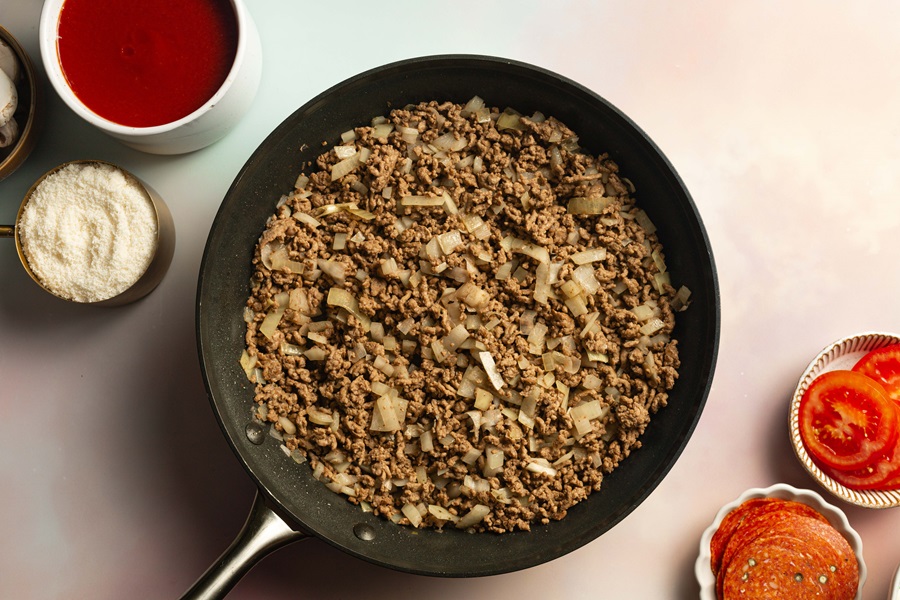 Keto Crockpot Casserole for Pizza Lovers Browned Ground Beef in a Pan on a Countertop