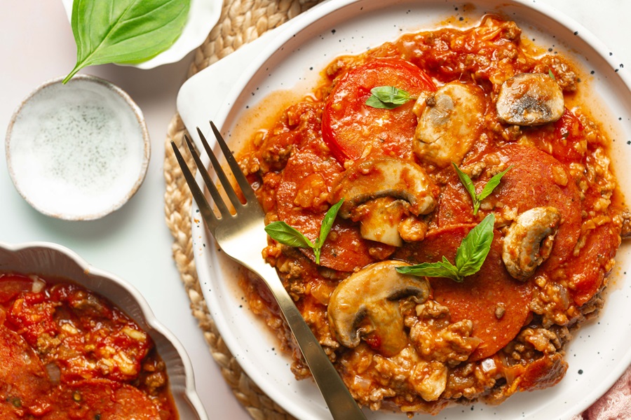 Keto Crockpot Casserole for Pizza Lovers a Plate of Pizza Casserole with a Fork