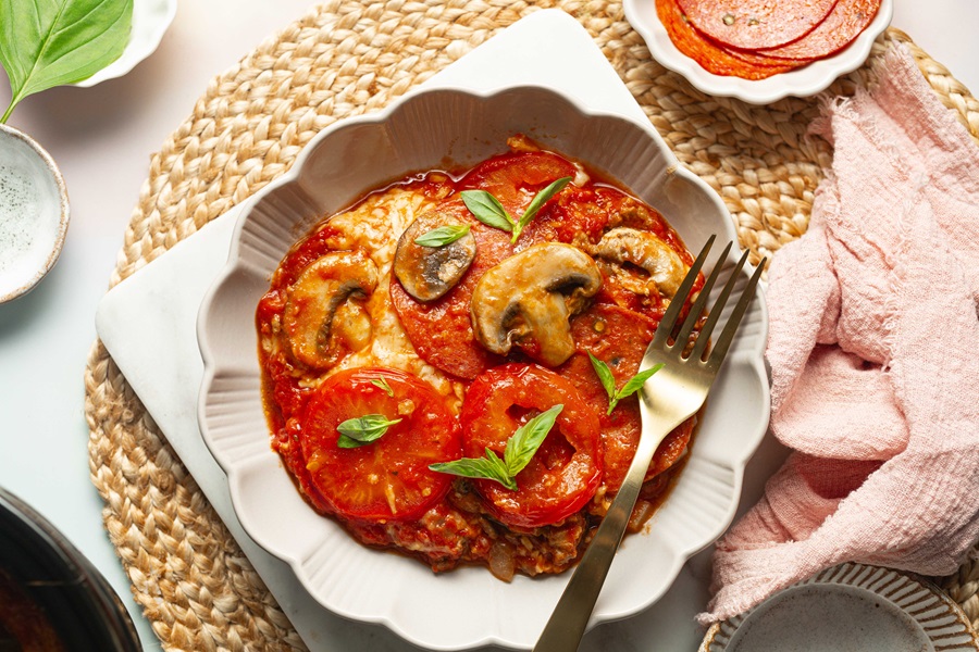 Keto Crockpot Casserole for Pizza Lovers Overhead View of a Platter with Pizza Casserole with a Fork