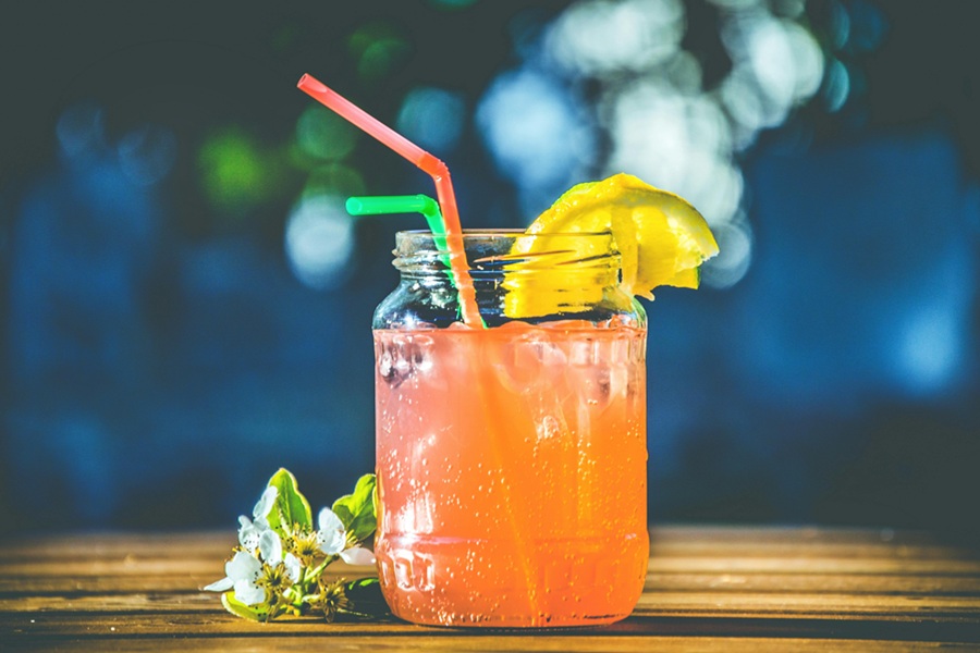 Fat Burning Juice Recipes Close Up of a Small Mason Jar Filled with Juice and Garnished with a Lemon Slice