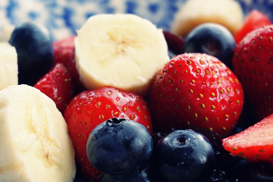 Fruit Crisp in the Air Fryer Close Up of Strawberries, Blueberries, and Sliced Banana in a Small Bowl